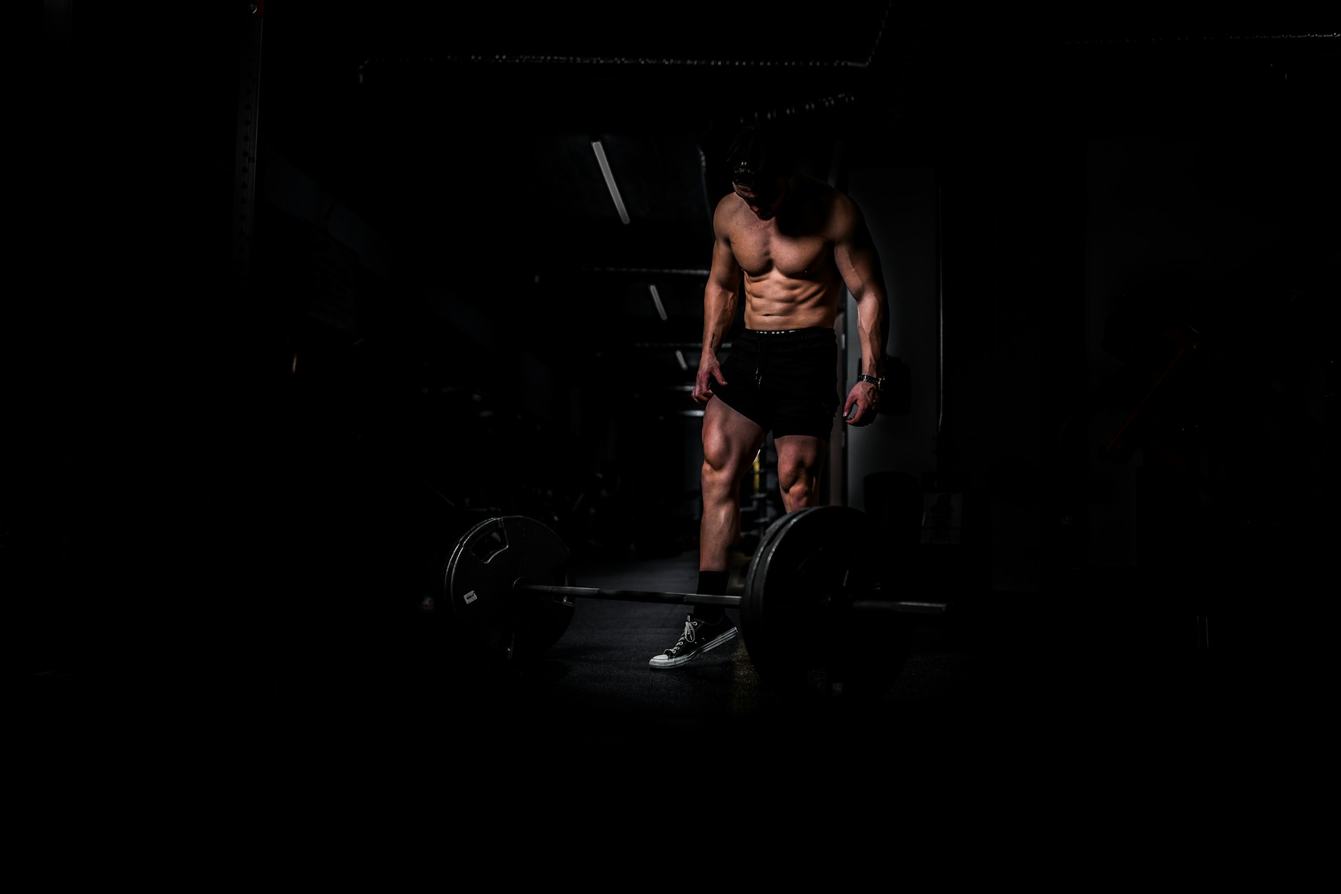 A person flexing their muscles in front of a mirror, showing the results of their dedication to building muscle and achieving fitness goals