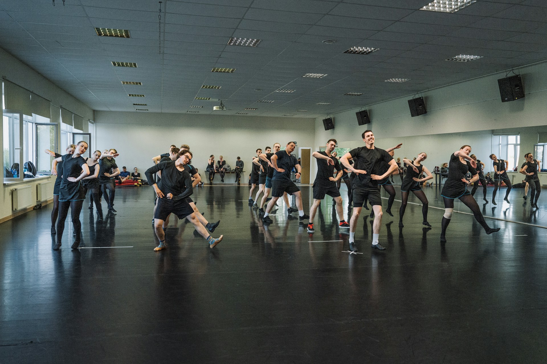 A group of people dancing energetically in a dance studio, showcasing dance as a fun and effective way to improve stamina