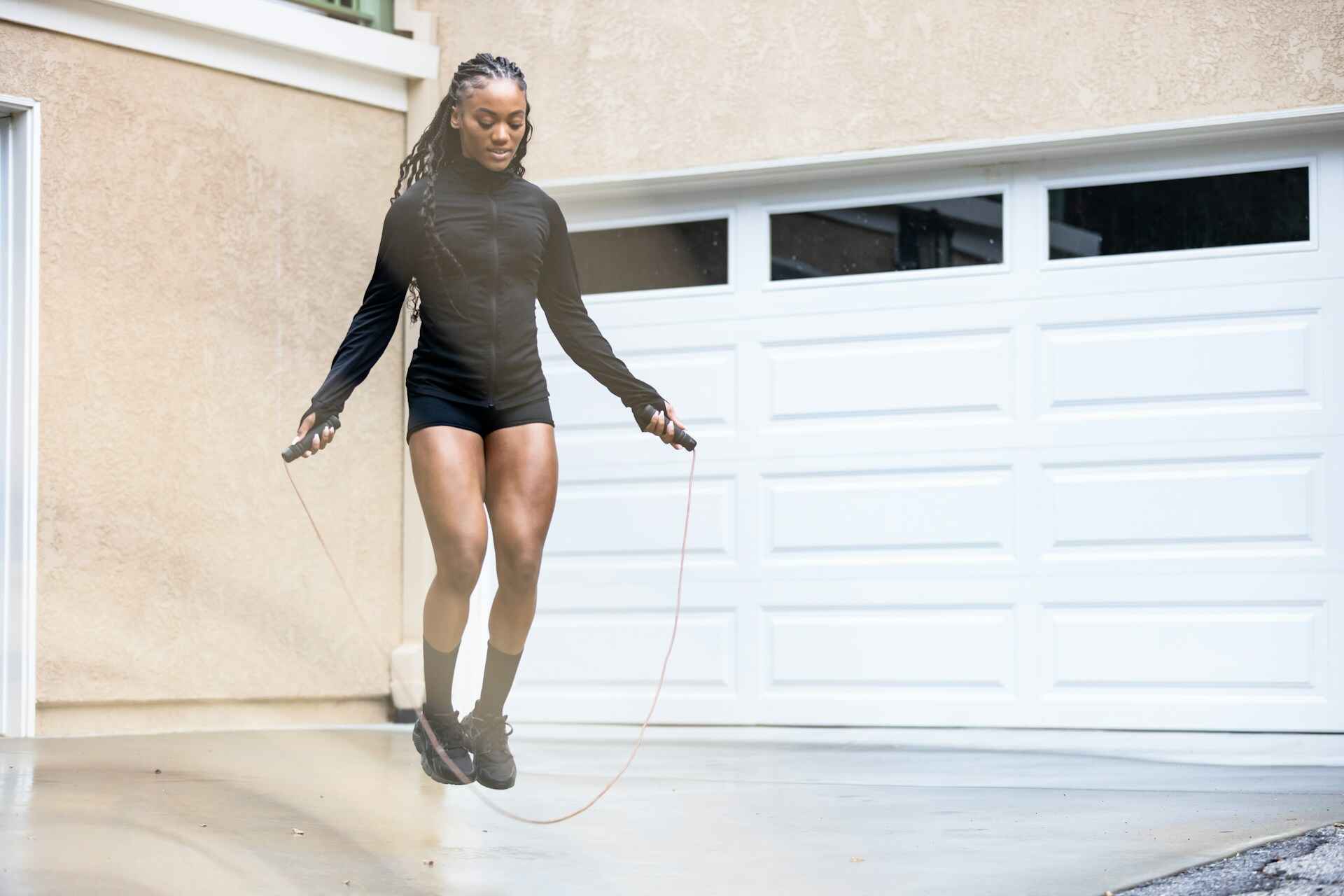 A person jumping rope in an urban setting, capturing the high-intensity nature and stamina-building benefits of jump rope exercises