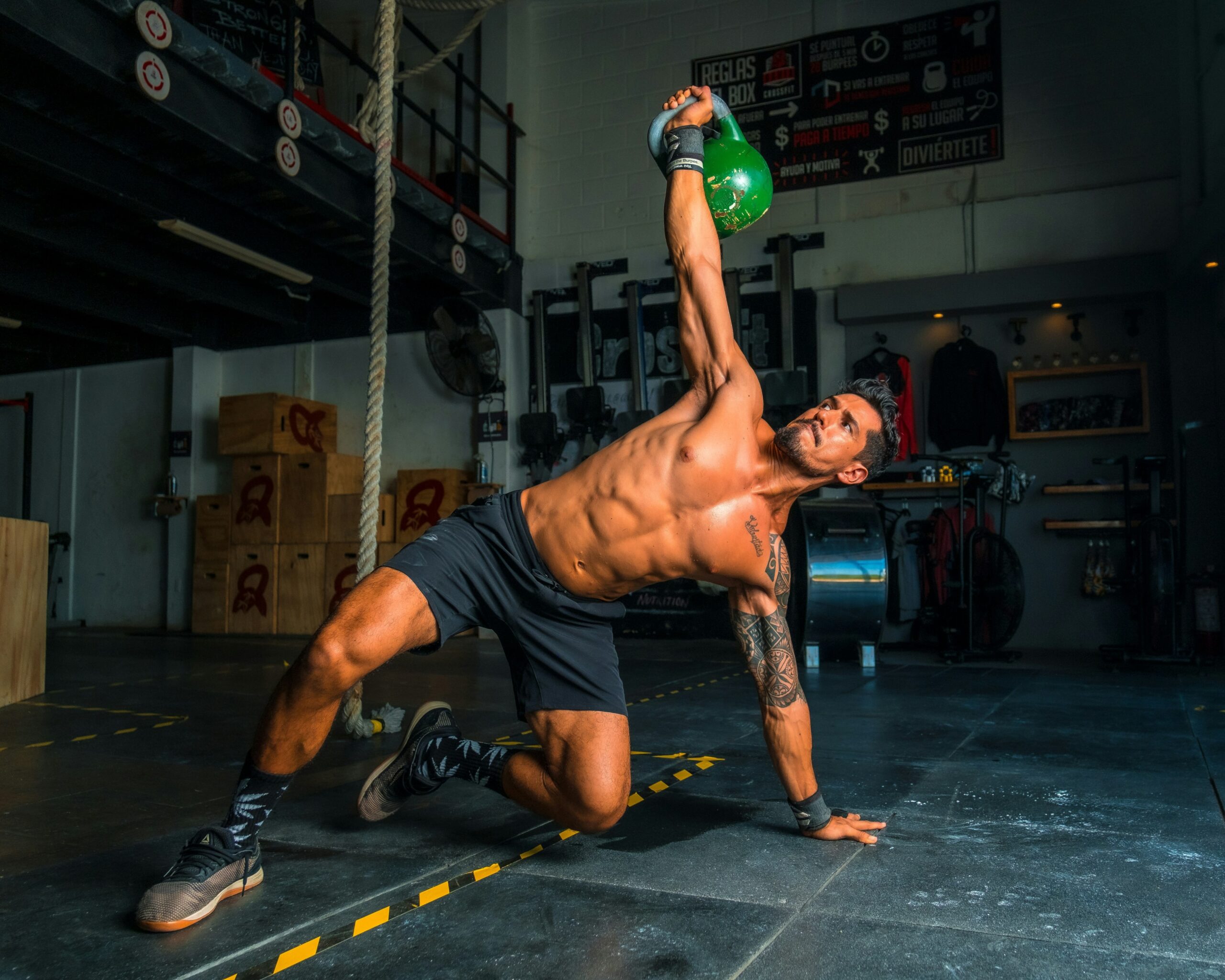 CrossFitters performing high-intensity functional exercises in a gym setting, highlighting the variety and intensity of CrossFit workouts