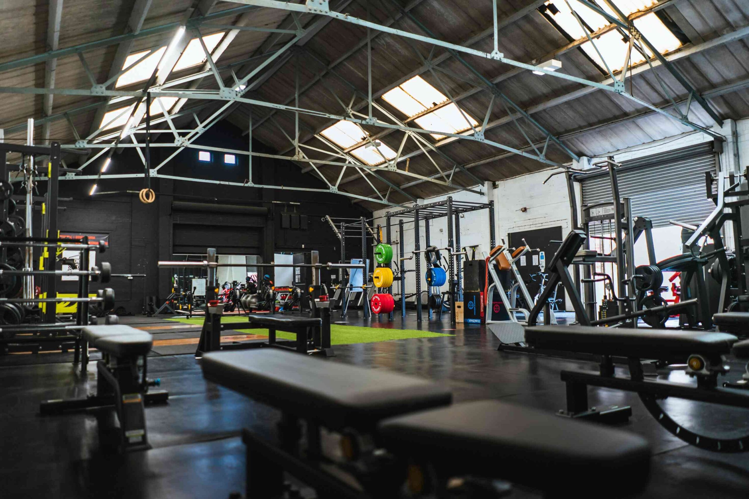 Interior of a gym with various exercise equipment like treadmills, weight machines, and free weights, showcasing the range of equipment available for gym workouts