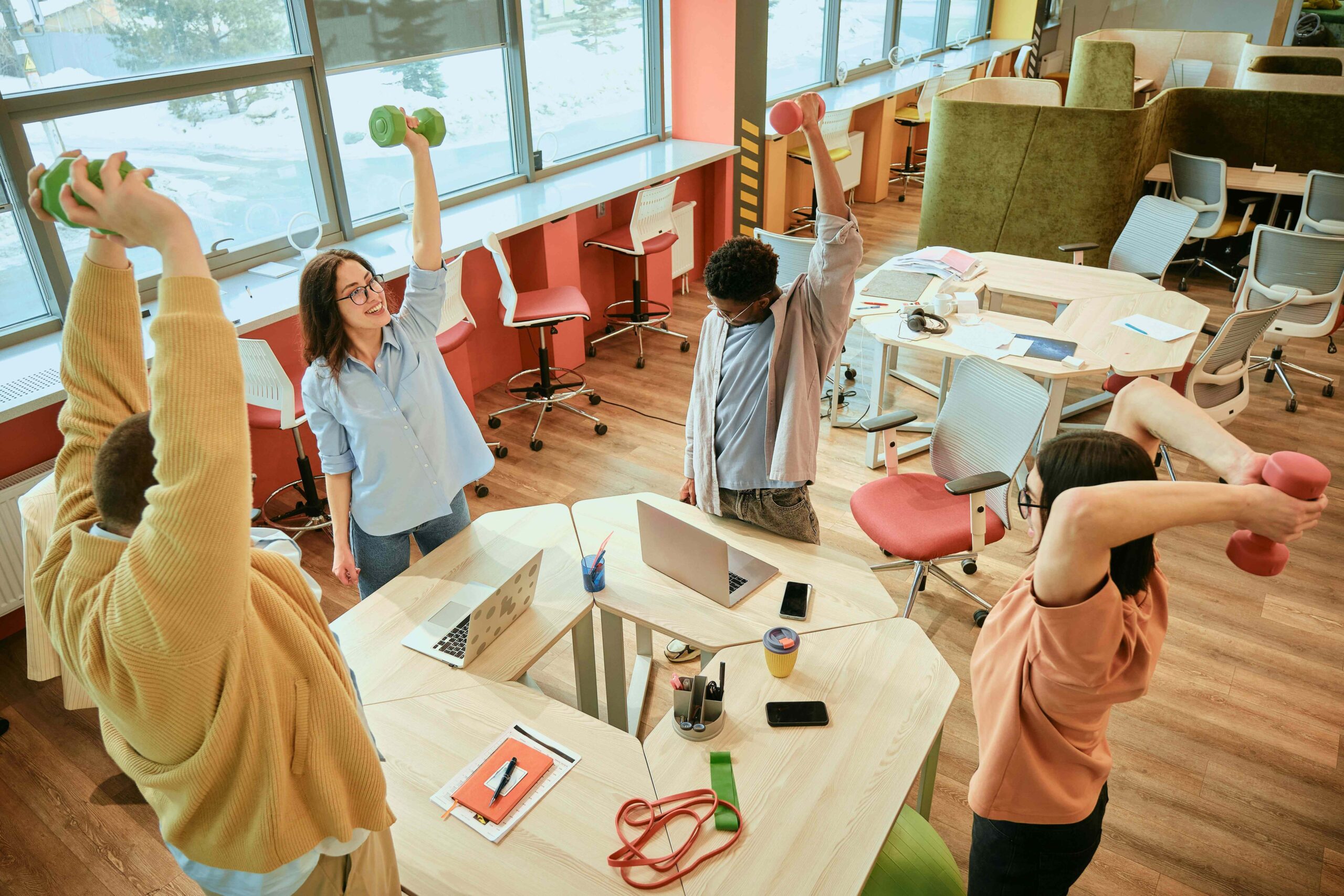 An office worker doing stretches at their desk, incorporating movement into their daily routine during short breaks